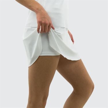 White tennis skirt worn by a person on a white background