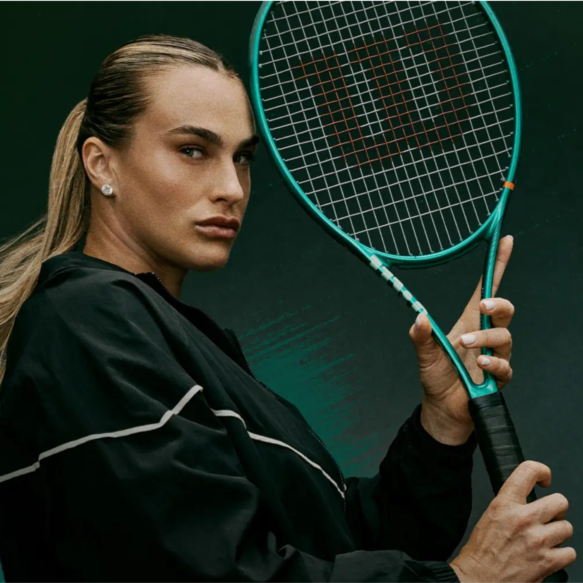 Aryna Sabalenka world number 1 tennis player holding Wilson Blade 98 16x19 v10 – 3/4 side view against a dark emerald green background