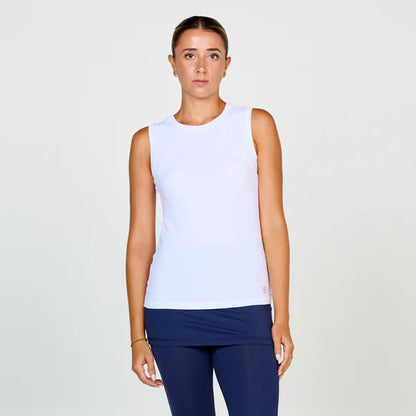 Woman wearing a white sleeveless top and blue leggings on a white background