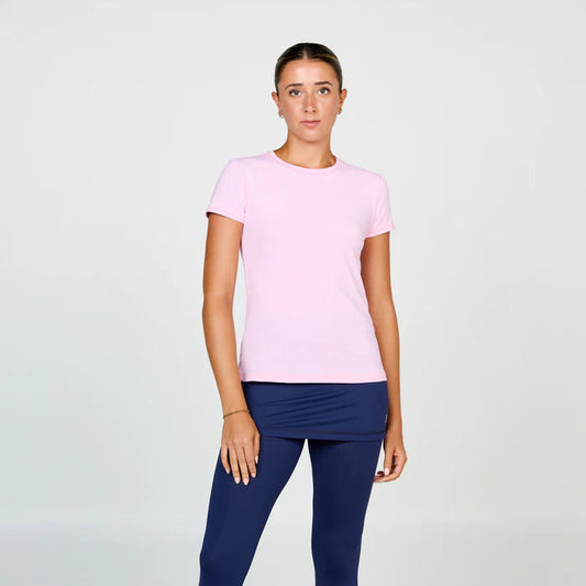 Person wearing a pink t-shirt and navy leggings on a white background