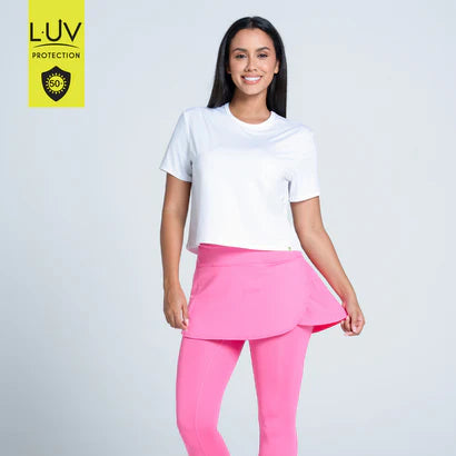 Woman wearing a white t-shirt and pink skirt with LUV Protection logo on a light gray background