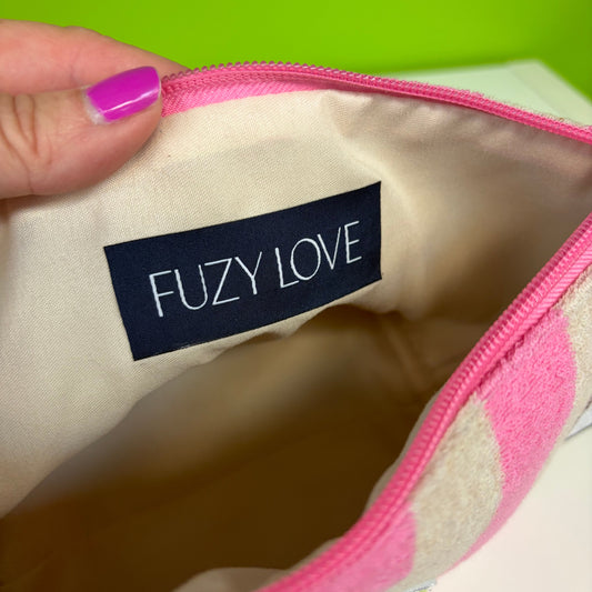 Close-up of a 'FUZY LOVE' label on a product with a pink and white pattern.