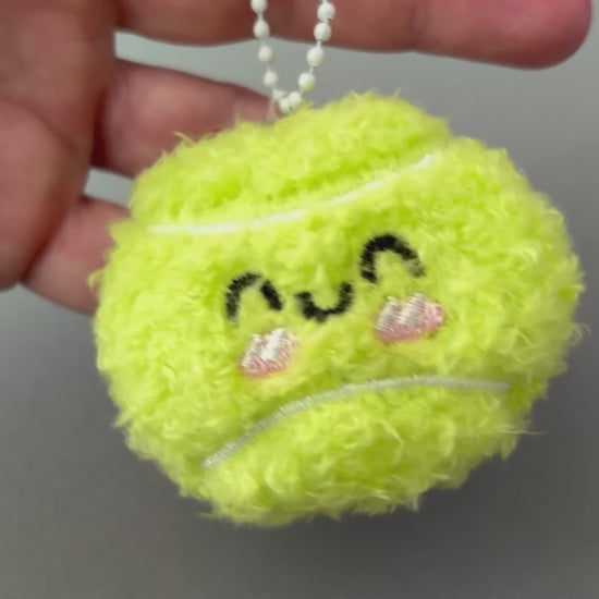 short video of cute plush tennis ball key chain charm